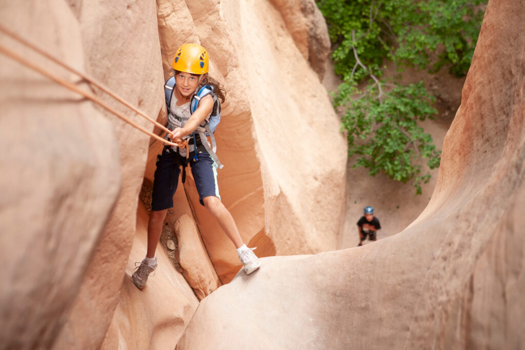 Young Girl rappelling in Yankee Doodle Canyon.